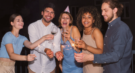 Pessoas com taças e chapéus de aniversário